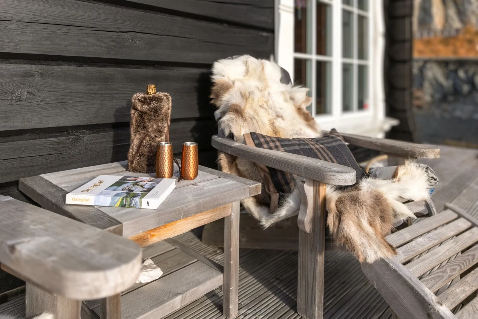 Sunny terrace seating with sheepskins at Sprudlebu