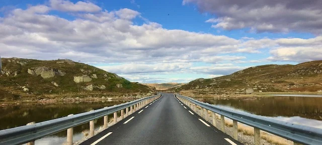 Road crossing the open Hardangervidda landscape
