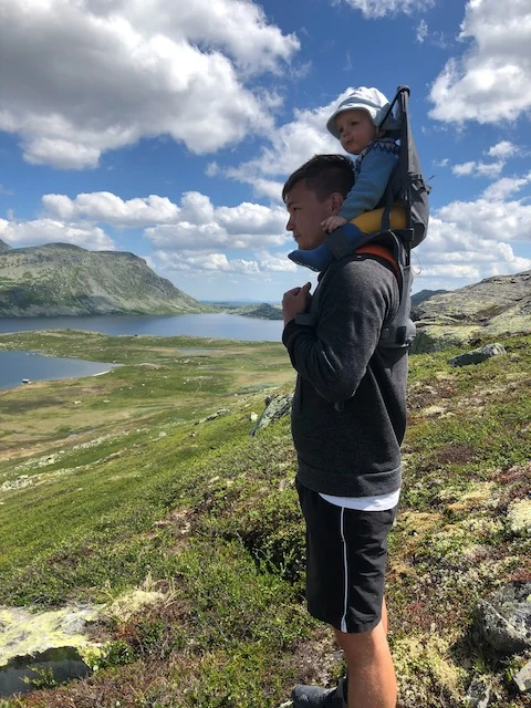 Walking in the mountains with a small child in a carrier